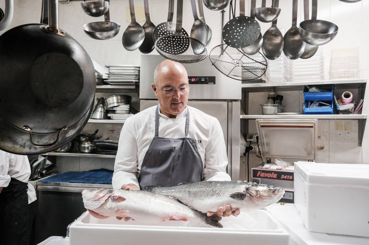 El chef Nelson Pérez posa con dos lubinas en la cocina de su restaurante en Arinaga (Gran Canaria). 