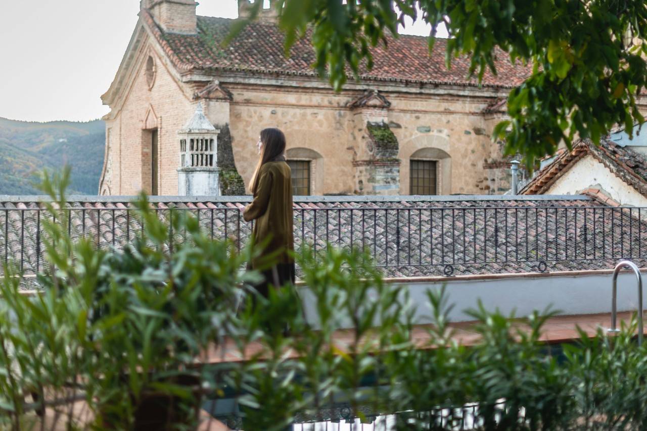 Una mujer mira al monasterio de Guadalupe.