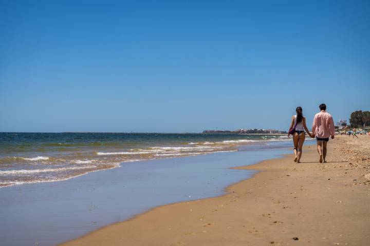 Dos personas paseando por Isla Cristina (Huelva)